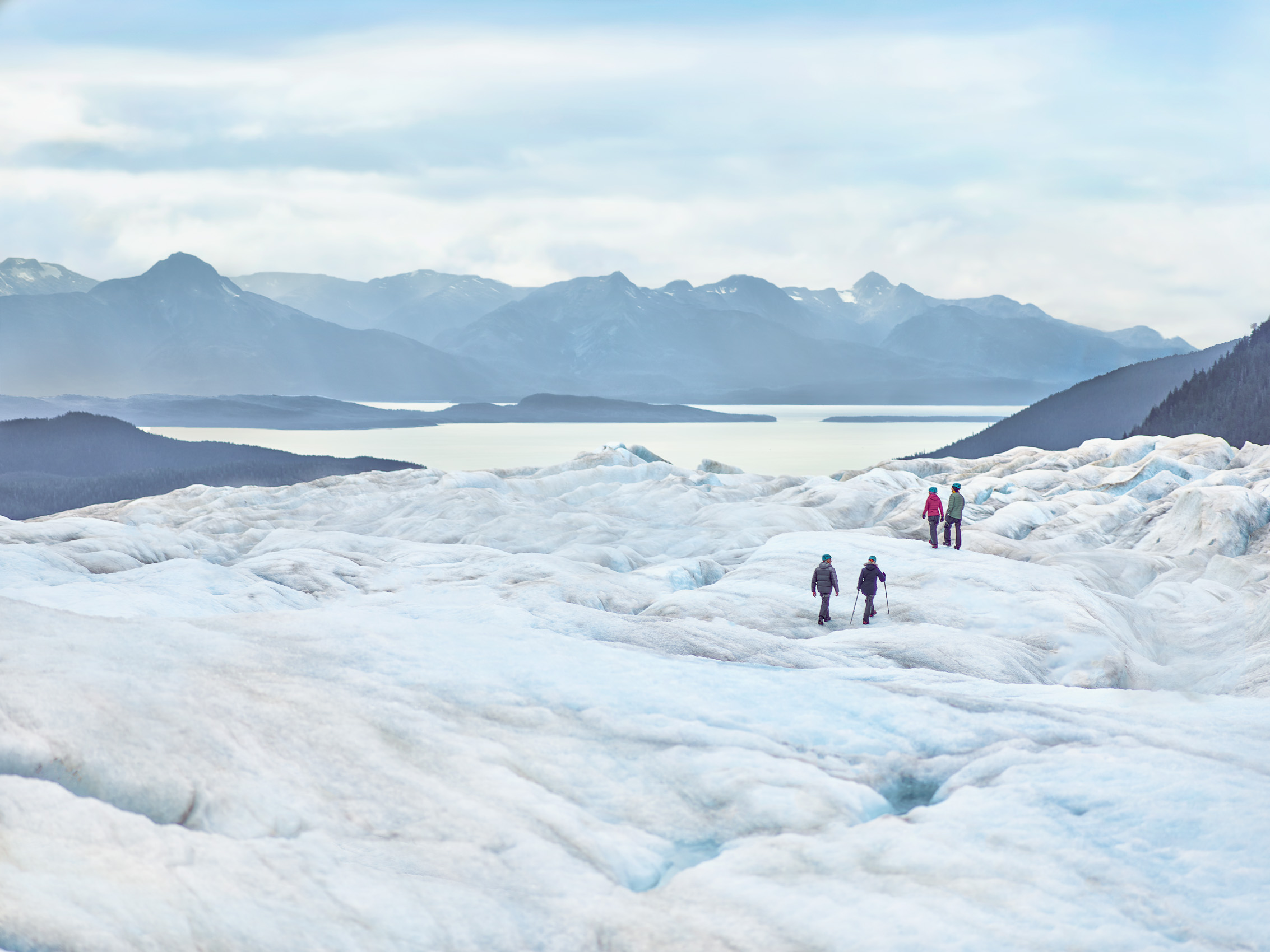 Couples hike on a huge glacier in Alaska