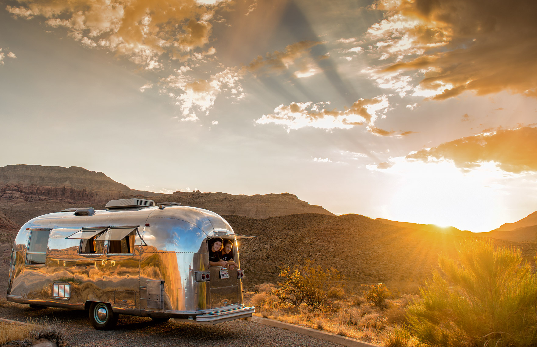 Kevin Steele - Young men look out of a vintage Airstream
