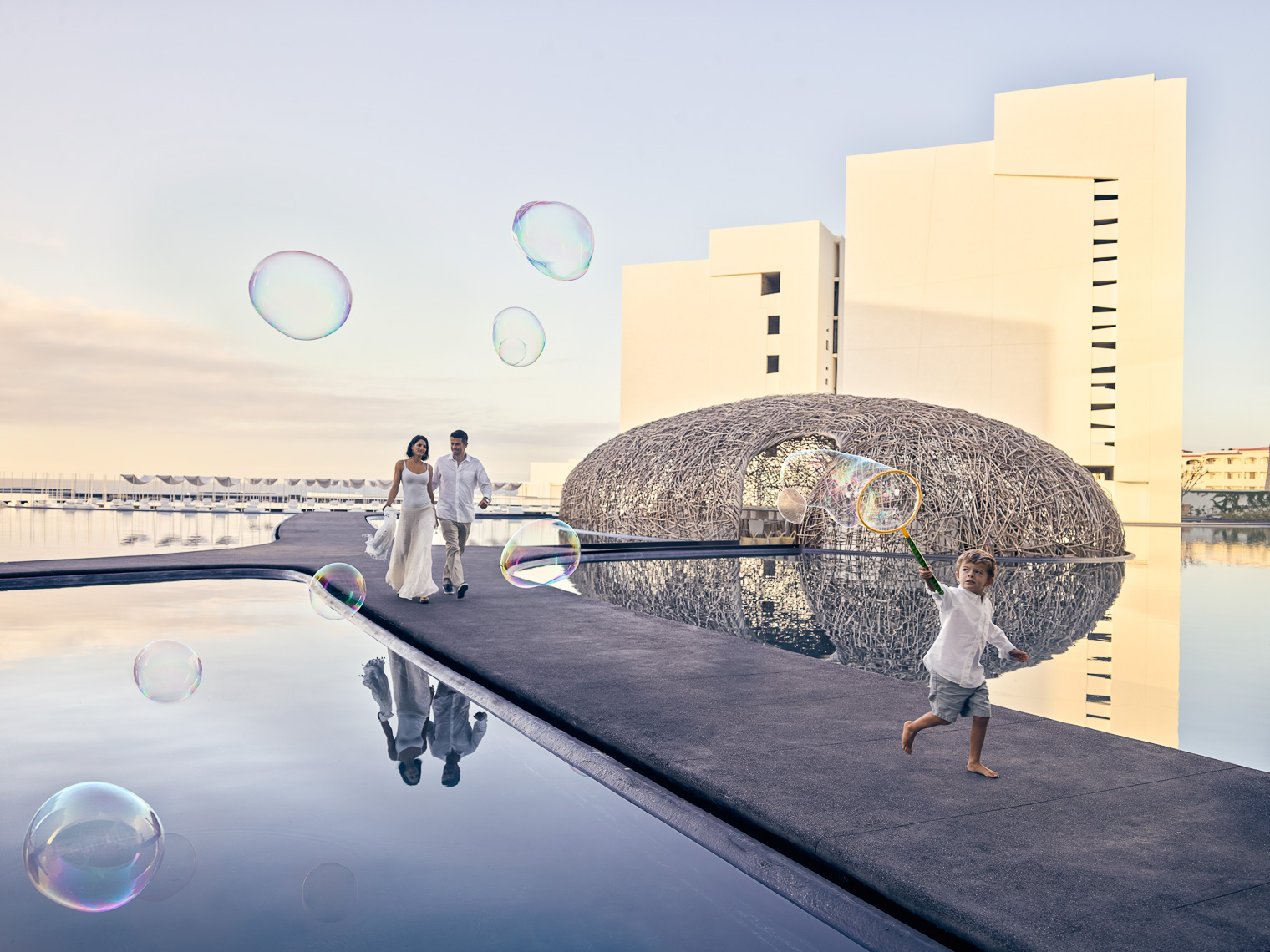 Kevin Steele - a boy runs with bubbles at a unique luxury hotel