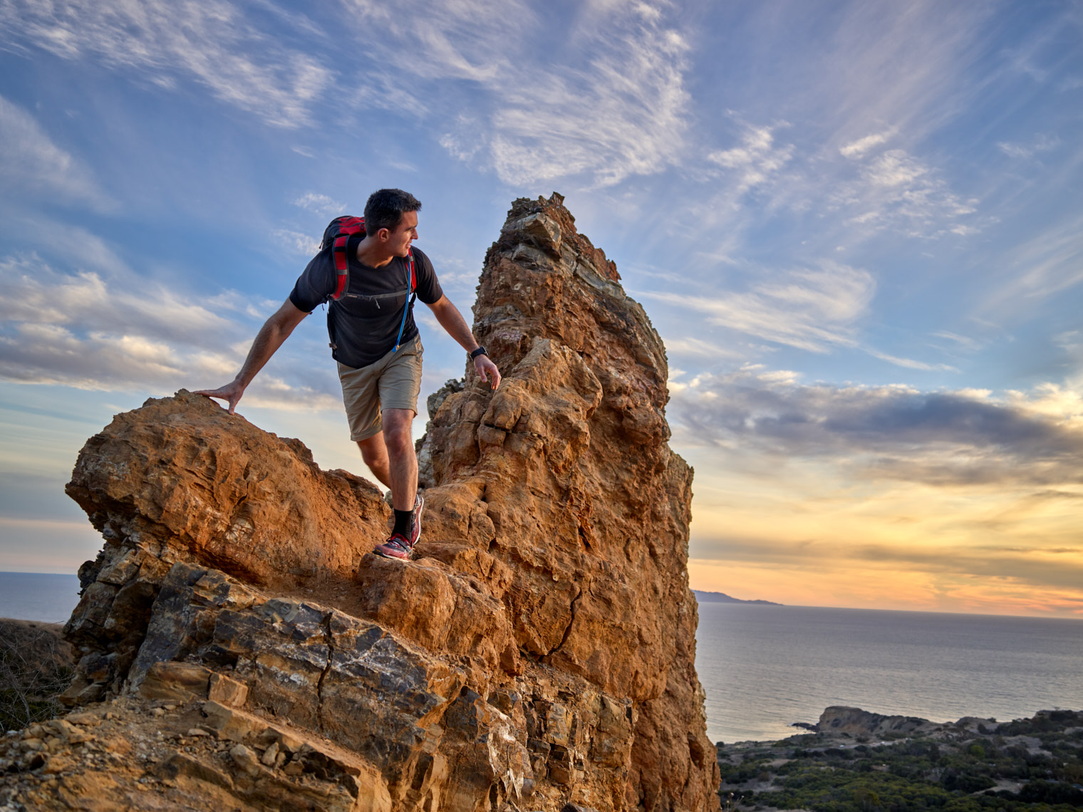 Kevin Steele - Hiking along a rocky ridge as the sun sets above LA