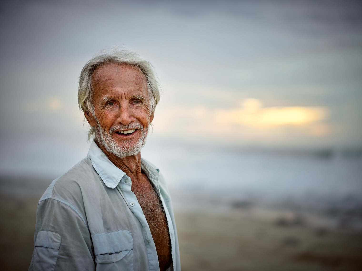 Kevin Steele - portrait of an older bearded man on the beach