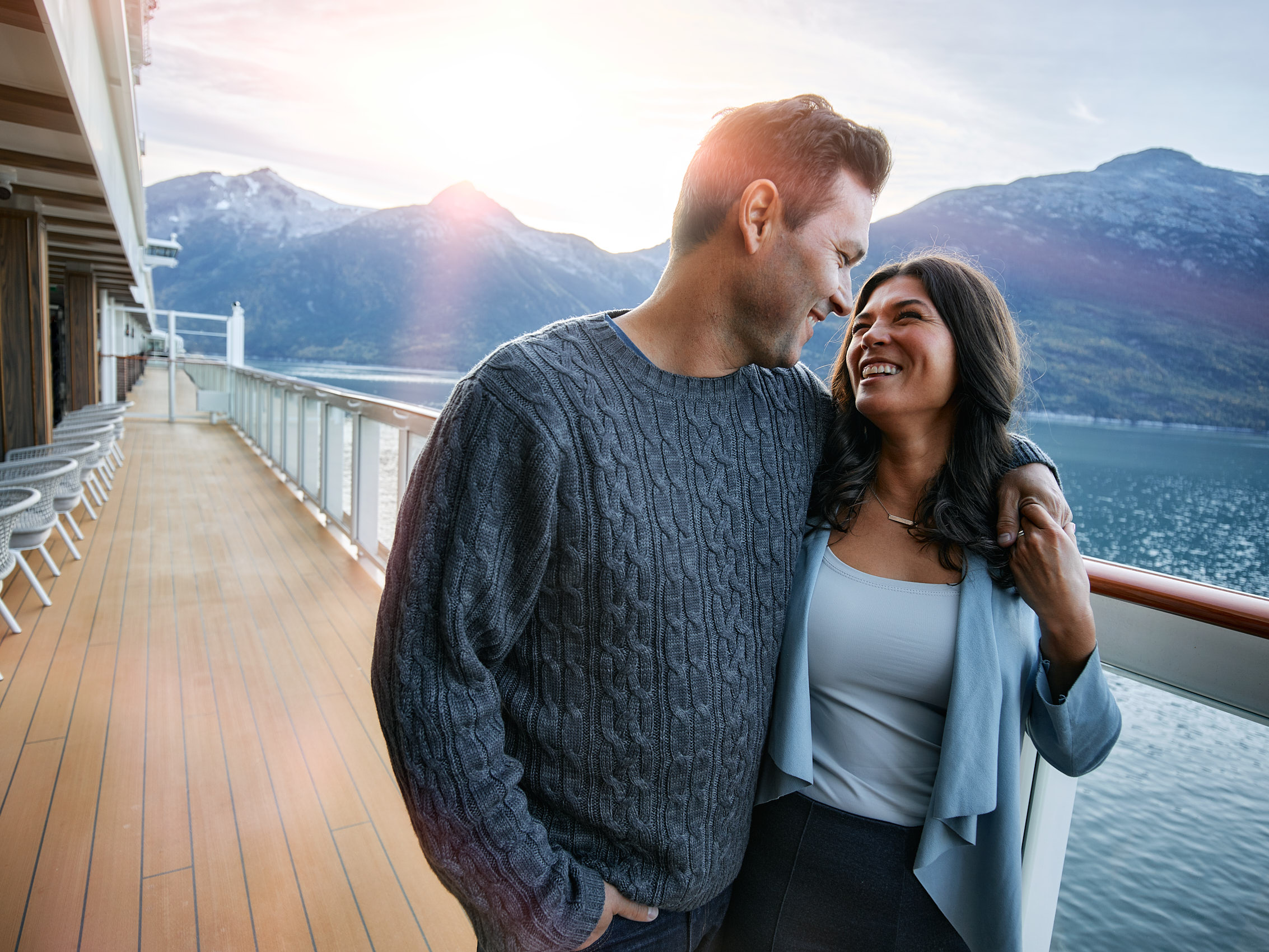 A romantic couple on the deck of an Alaskan cruise ship.