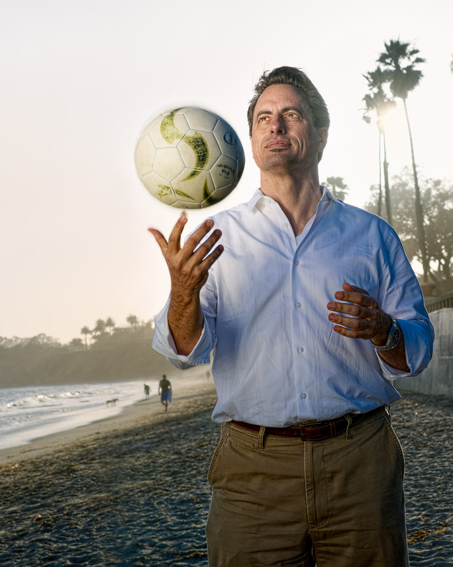 Kevin Steele  - portrait of a man and soccer ball on the beach