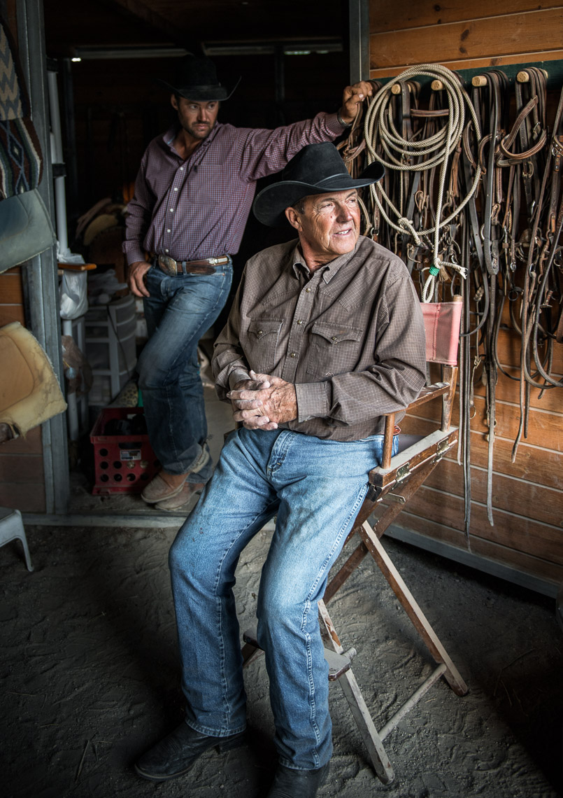 Kevin Steele - portrait of two cowboys in the barn