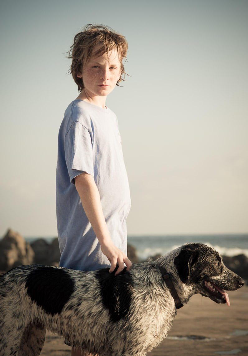 Kevin Steele - portrait of a boy and dog on the beach